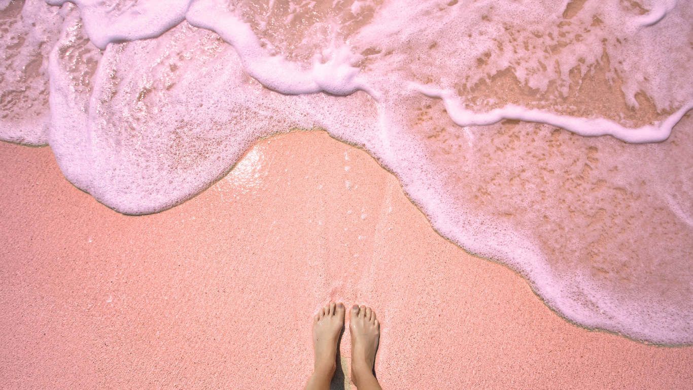 woman-standing-on-pink-sand-beach