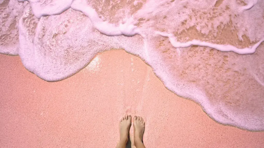 woman-standing-on-pink-sand-beach