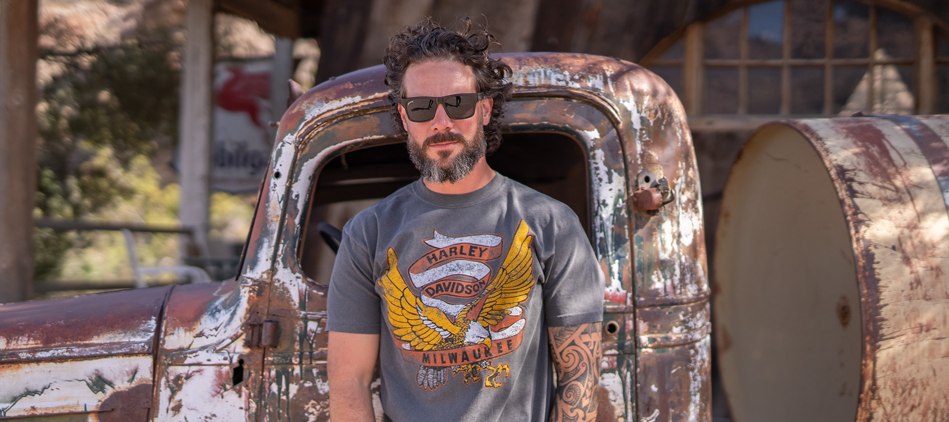 Man in t-shirt with eagle in front of pickup truck