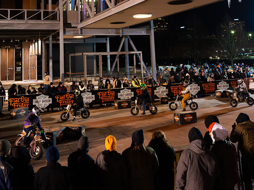 several motorcycles riding on a street