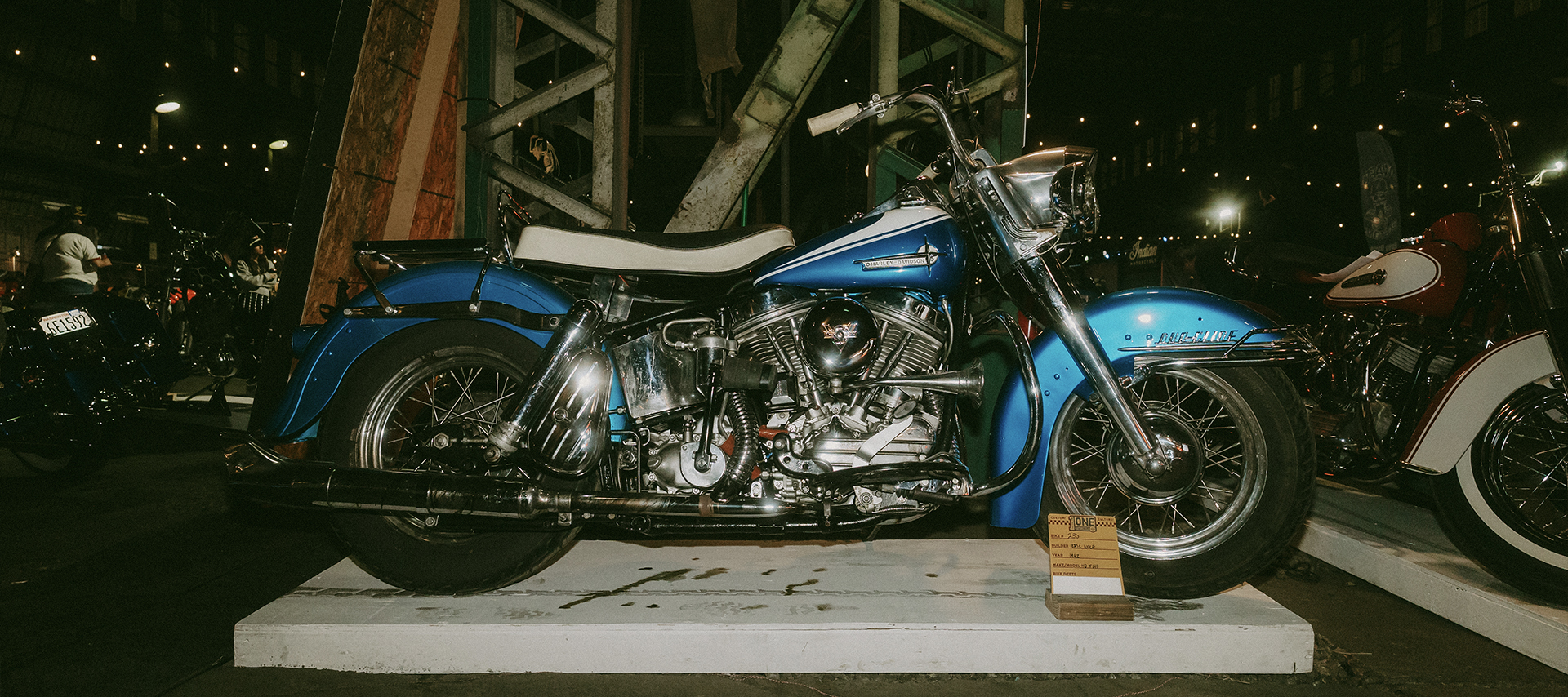 A profile image of a blue and white Harley on one of the viewing stands for the show. 