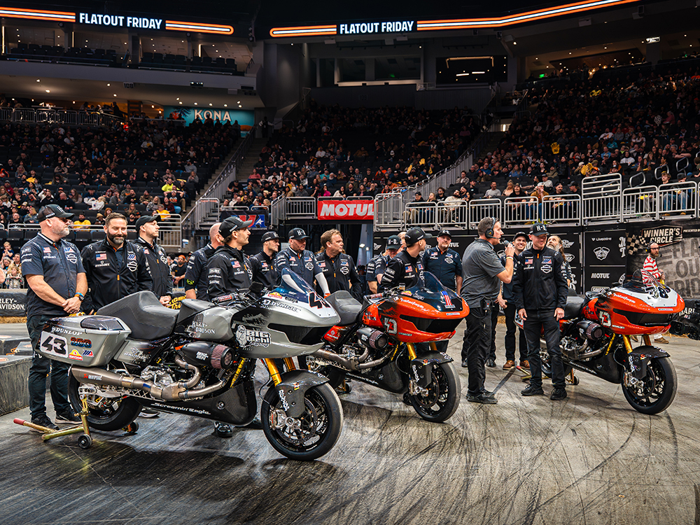 H-D Factory Racing drivers and crew standing by their race motorcycles