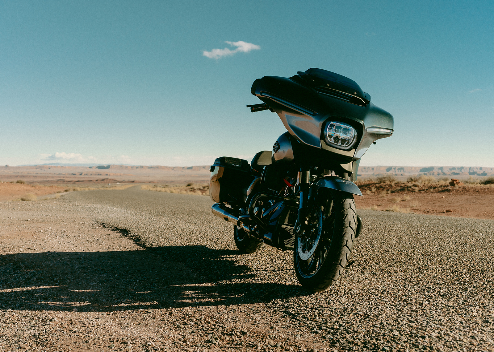 Black bike posed with the desert in the background