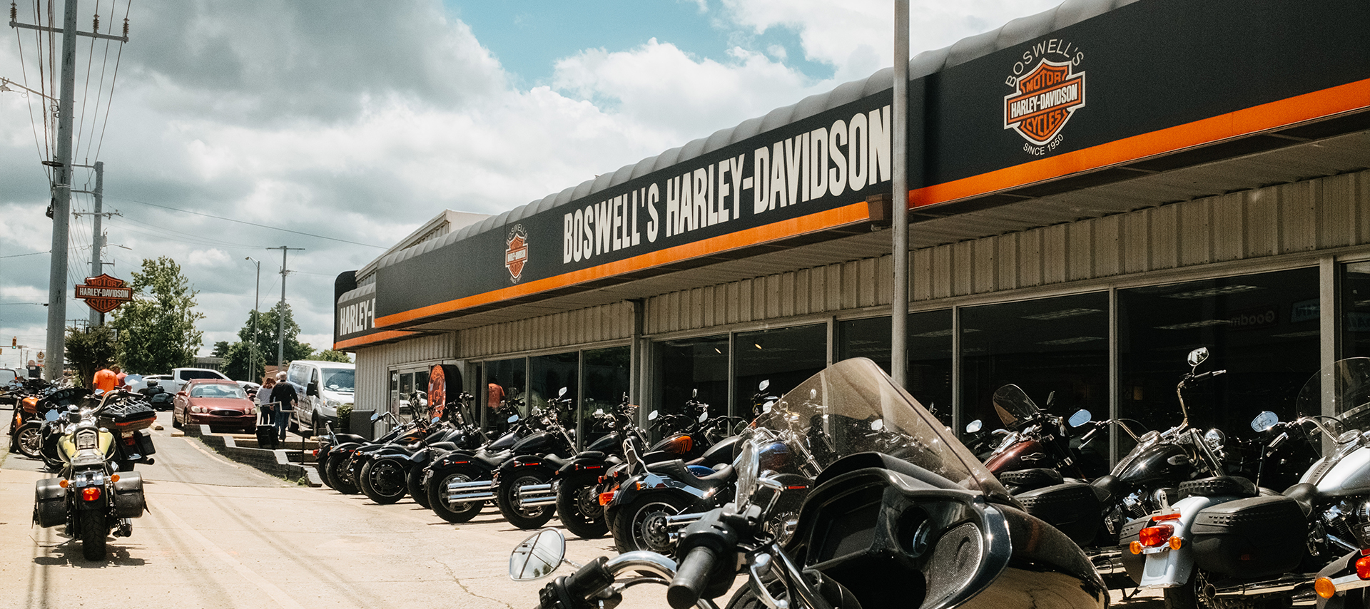 The exterior of Boswell’s Harley-Davidson dealership with a row of bikes parked out front.