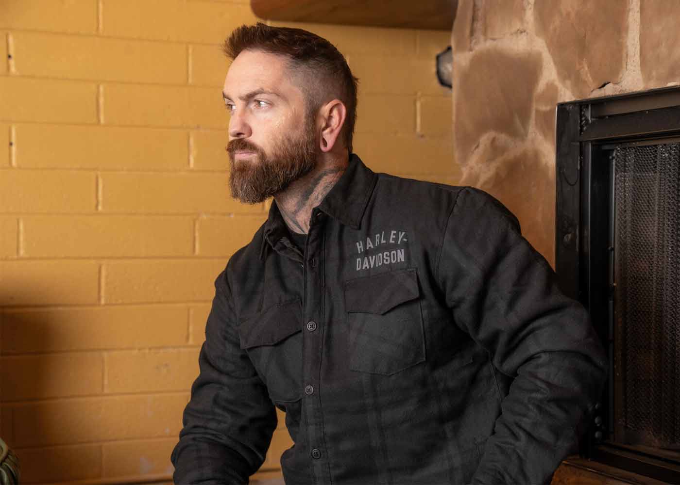 Man with beard wearing long-sleeve plaid shirt