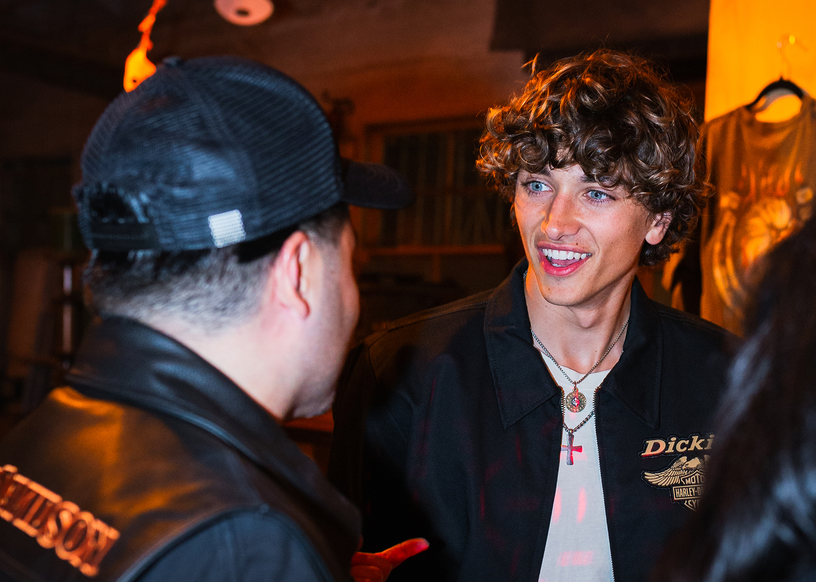 Two men in H-D x Dickies jackets talk excitedly. 
