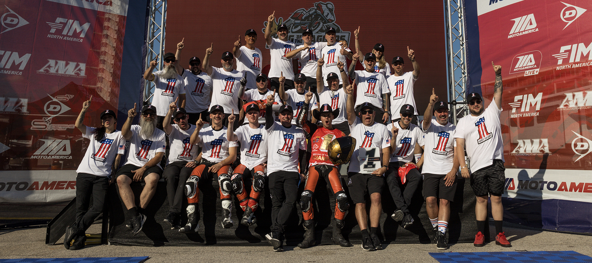 Kyle Wyman surrounded by the Harley-Davidson Factory Racing team celebrates victory on the podium at Circuit of the Americas.