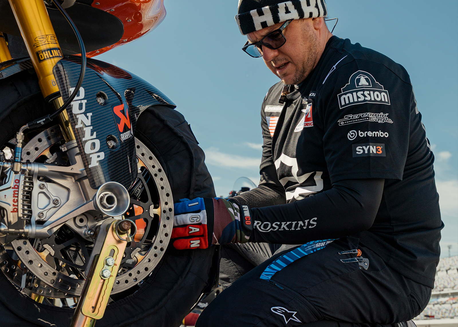 Mechanic puts a tire warmer on a motorcycle front tire