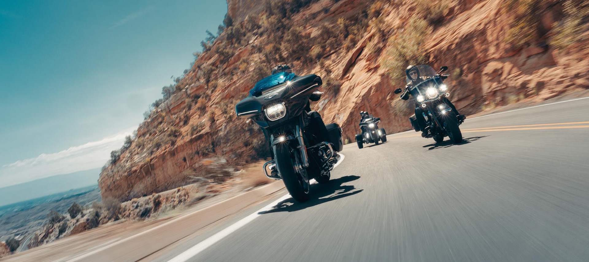 Group of motorcycles riding on winding mountain road