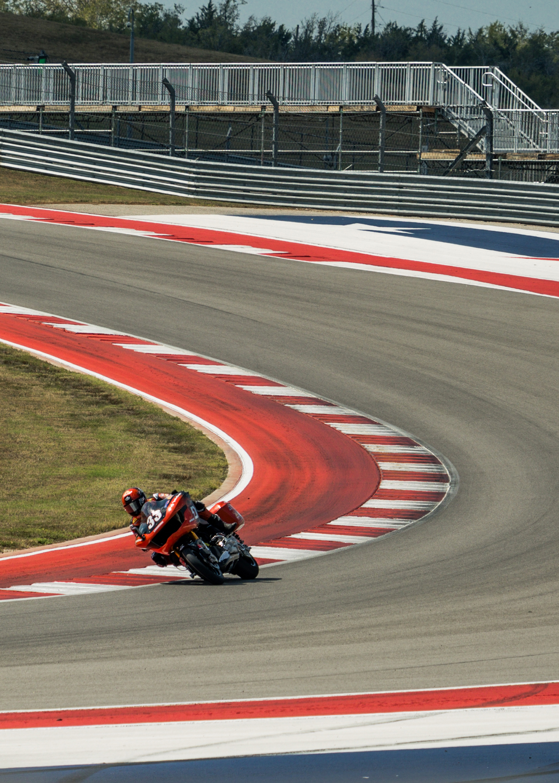  Number 33 Kyle Wyman drags a knee through a sharp turn at Circuit of the Americas.