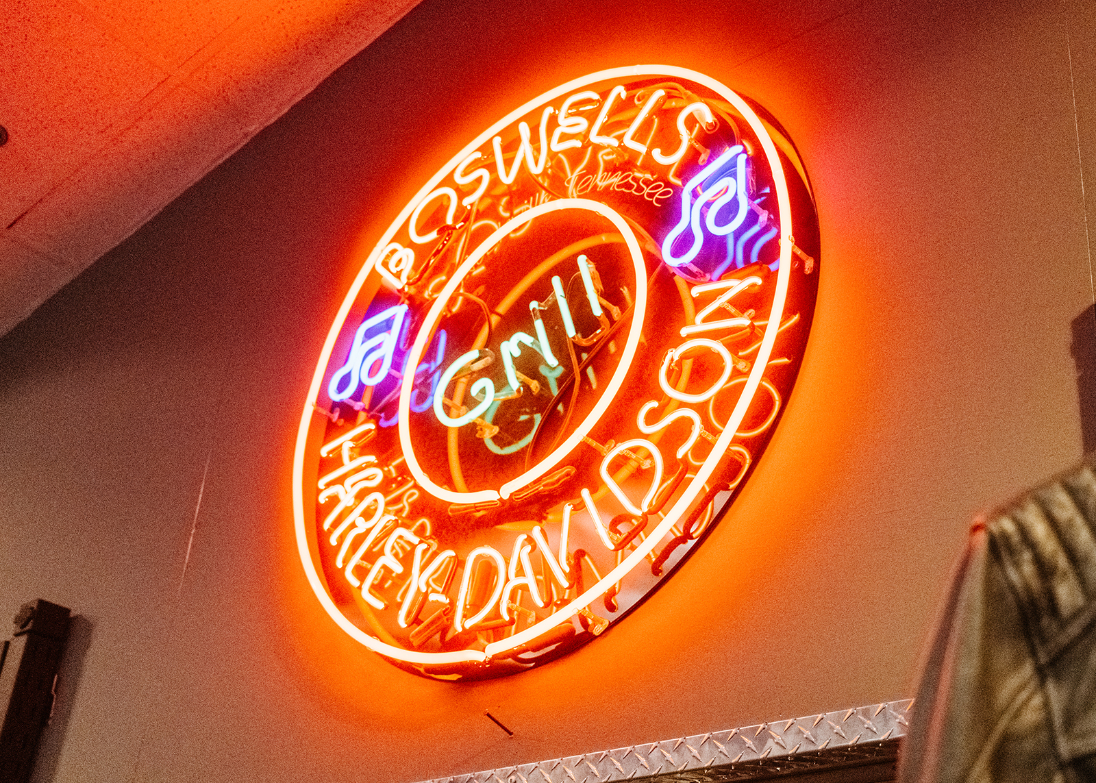 The blue and red neon sign for the diner style restaurant located within Boswell’s Harely-Davidson.