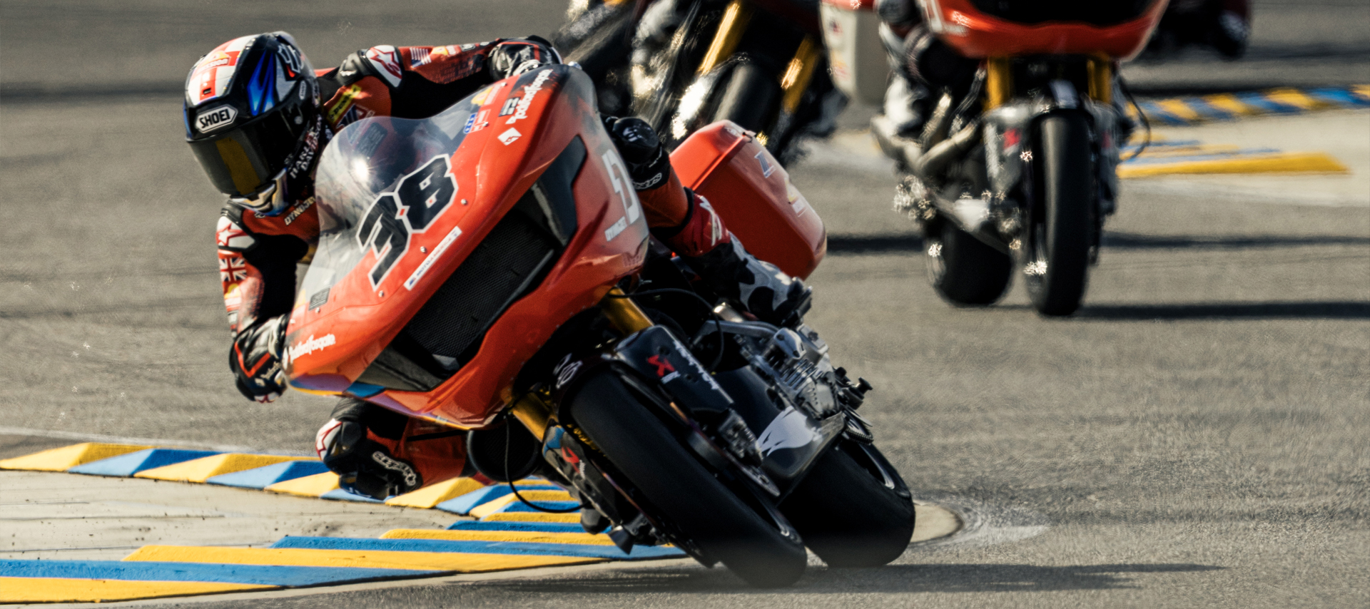 Bradley Smith gets low in a corner on his number thirty-eight motorcycle