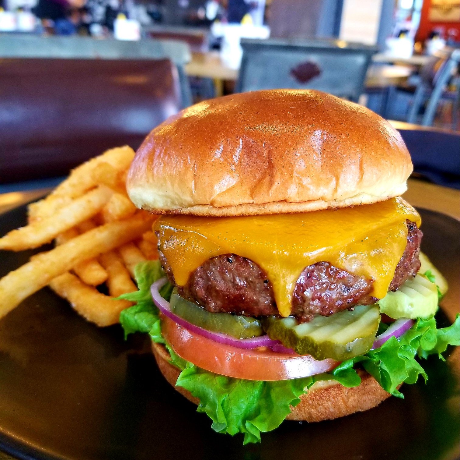 Cheeseburger with all the toppings and french fries