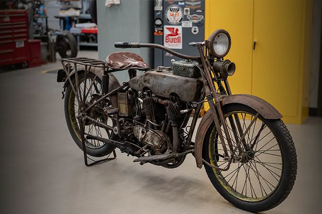 Vintage Harley-Davidson motorcycle on display inside workshop setting