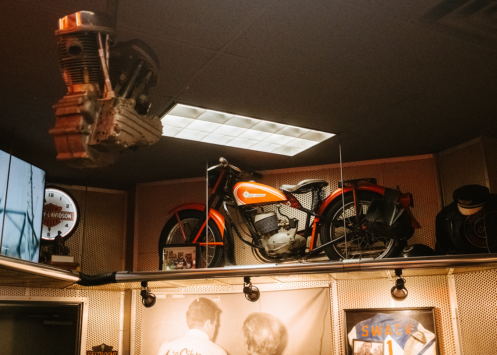 The interior of Boswell’s Harley-Davidson featuring vintage bike in the rafters.