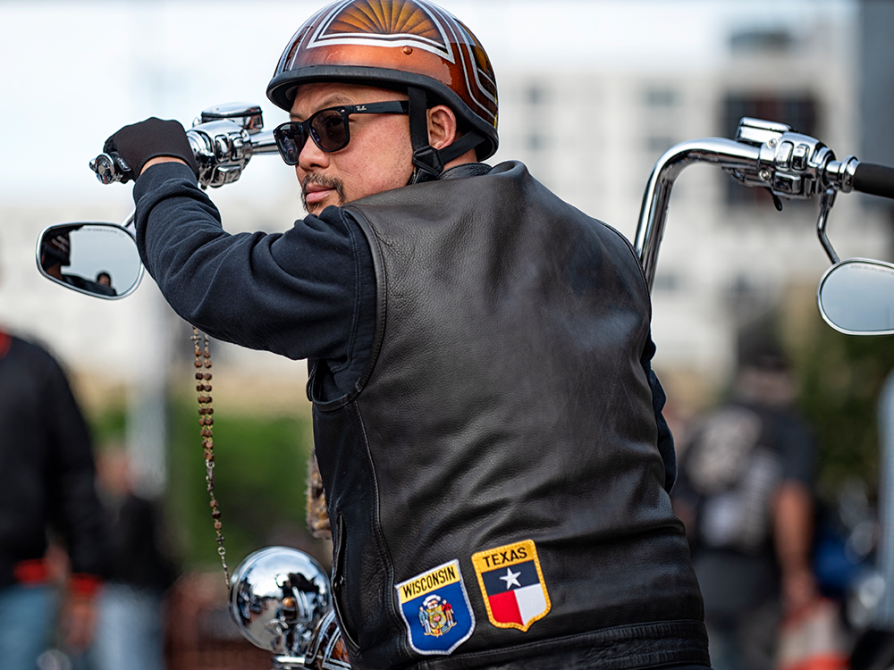 Motorcyclist on custom bike with tall handlebars