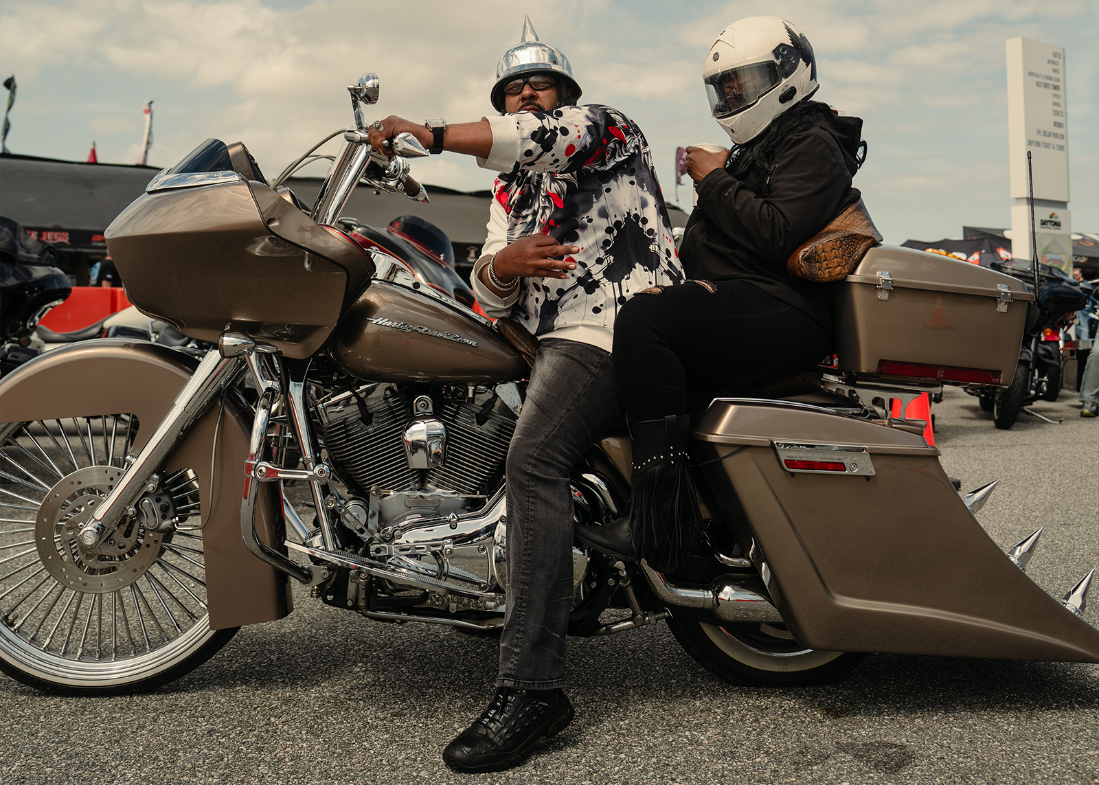 A man and woman pose on their fully customized Road Glide 
