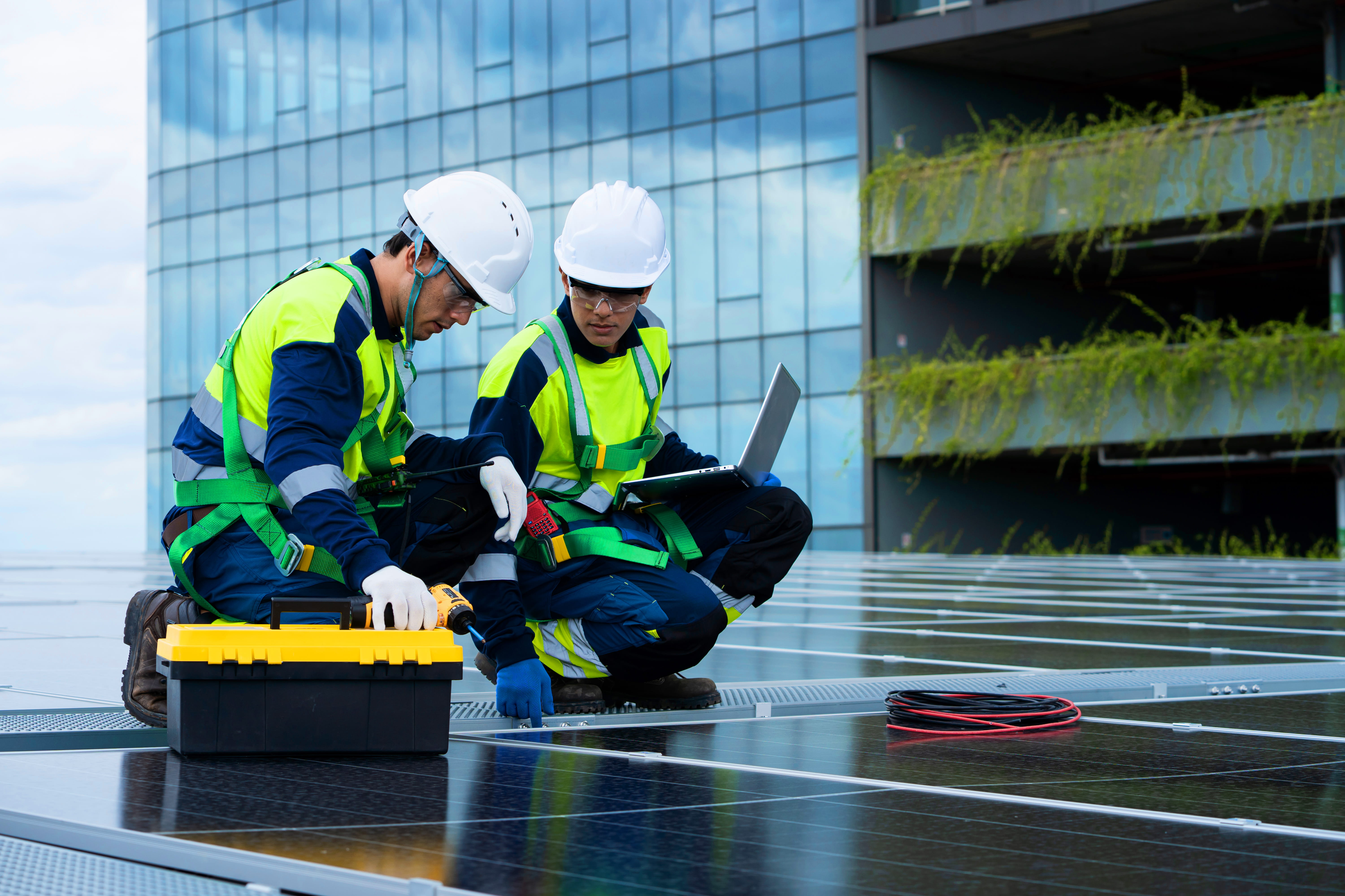 two-men-in-safety-gear-are-working-on-a-solar-pane-2026-01-11-10-12-18-utc (1)