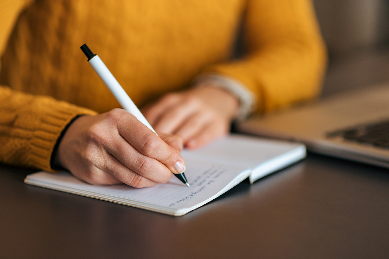 Man Writing in Notebook