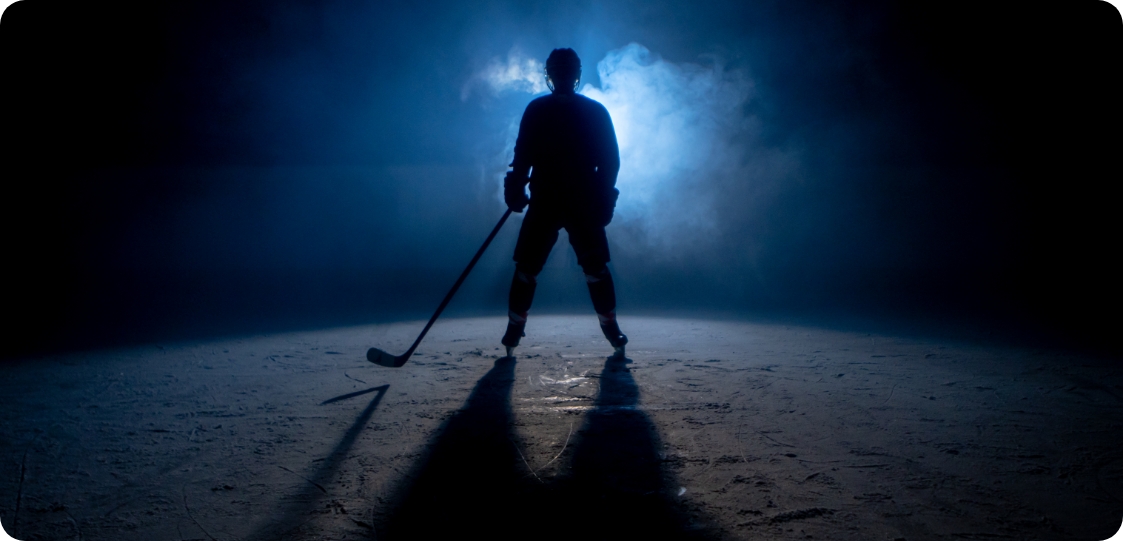 Photo d’un joueur de hockey la nuit.  