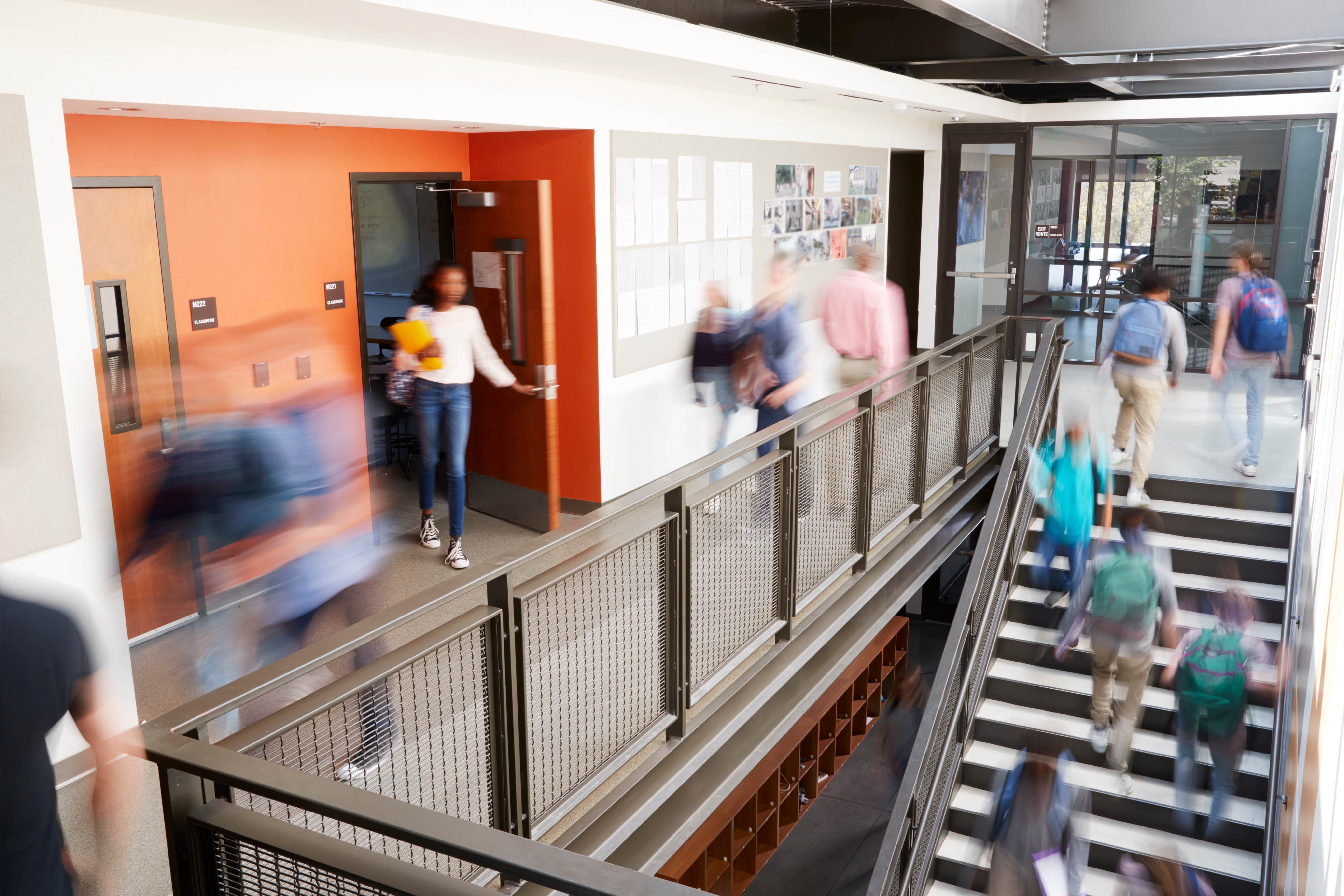 Photo de plusieurs jeunes dans une école qui montent un escalier.  