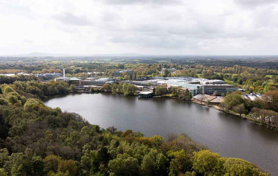 Aerial view of lake with surrounding low office buildings and trees