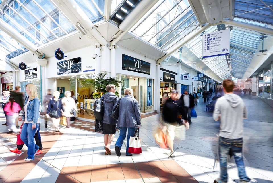 Inside the Mill Gate shopping centre including shoppers and shop fronts