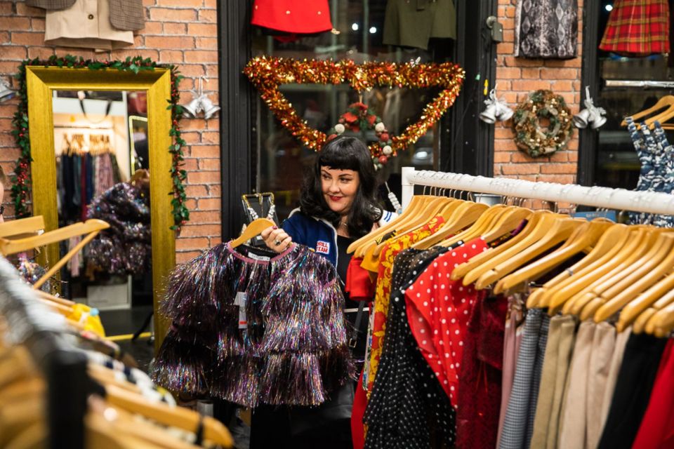 A woman browsing vintage clothing at Afflecks