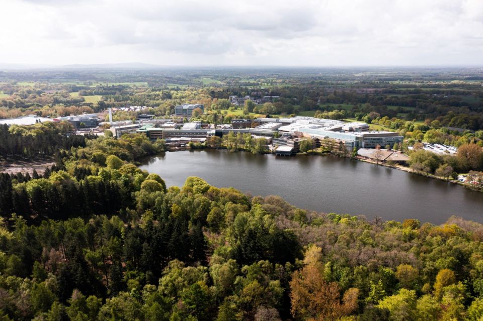 drone picture of alderley park mere and buildings 