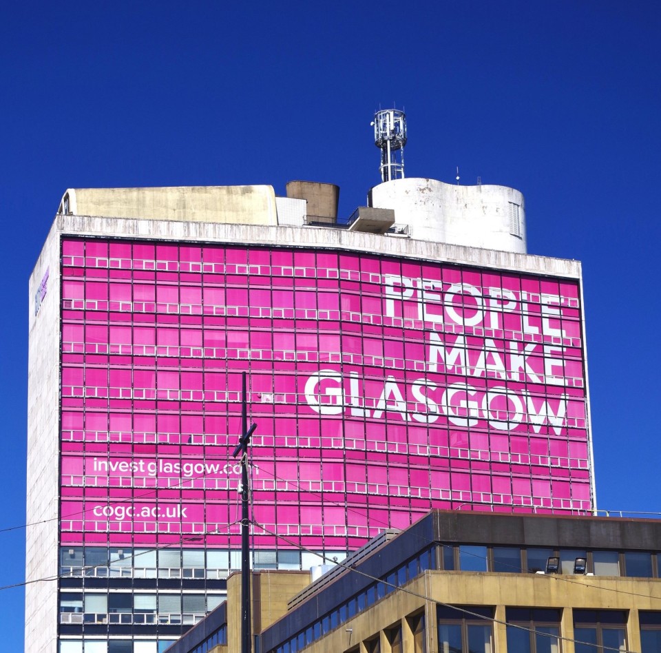 met tower people make glasgow sign close up