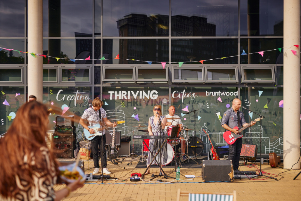 live band playing in front of the entrance of Innovation Birmingham at the Summer Party