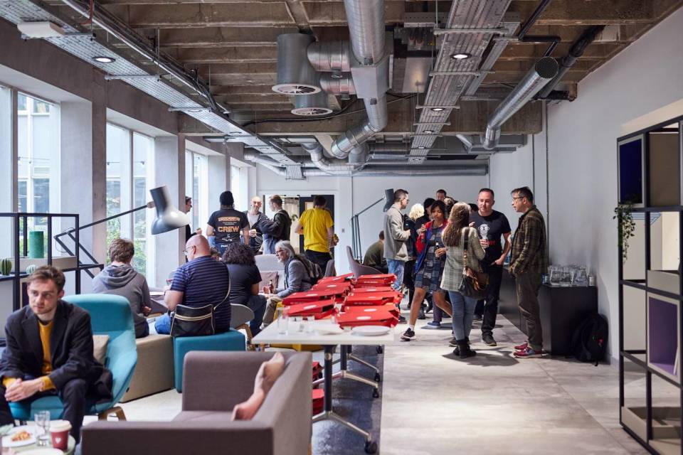 group of people talking inside at Manchester Technology Centre