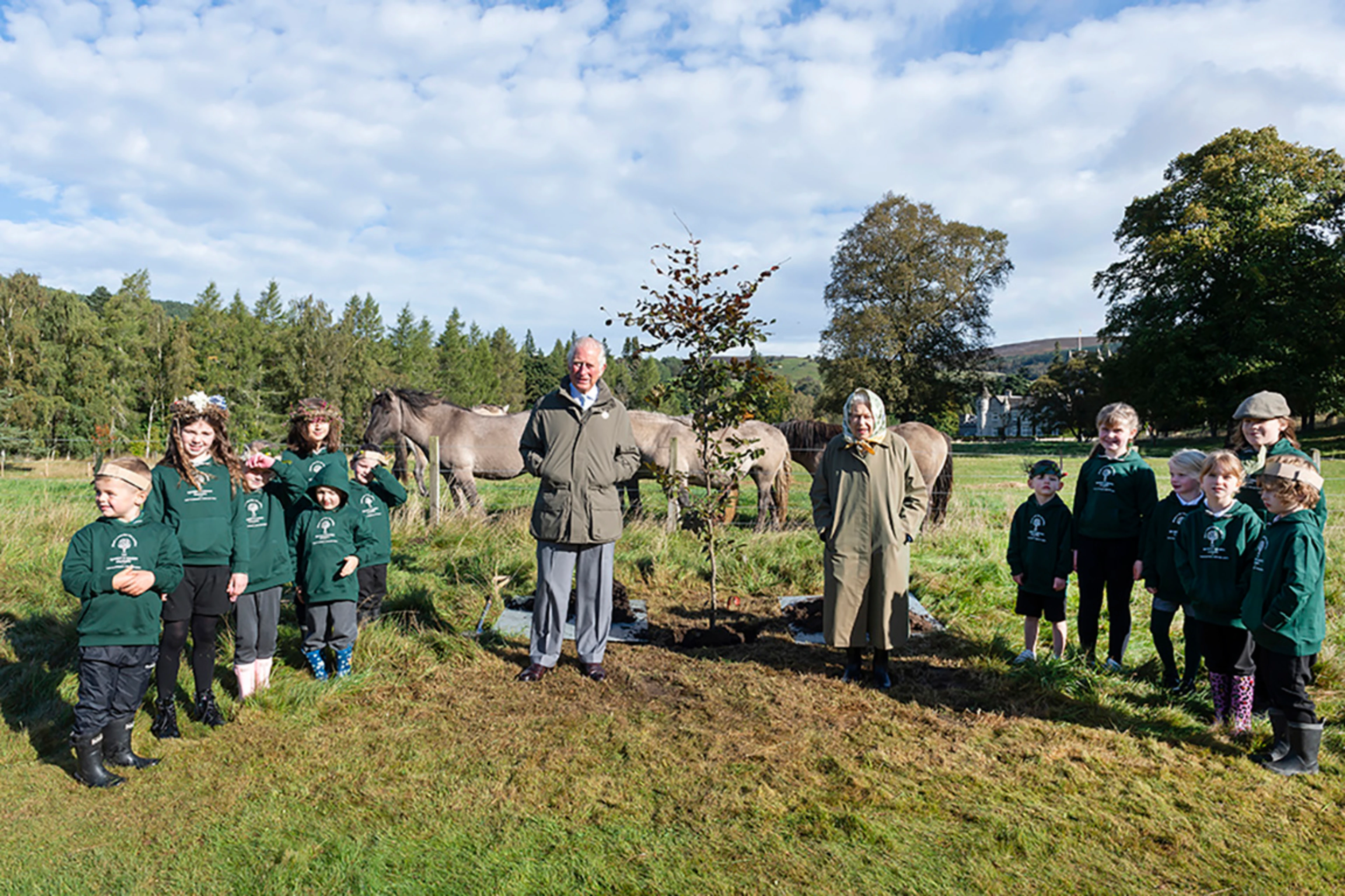 The Queen and Prince Charles with schoolchildren at Balmoral