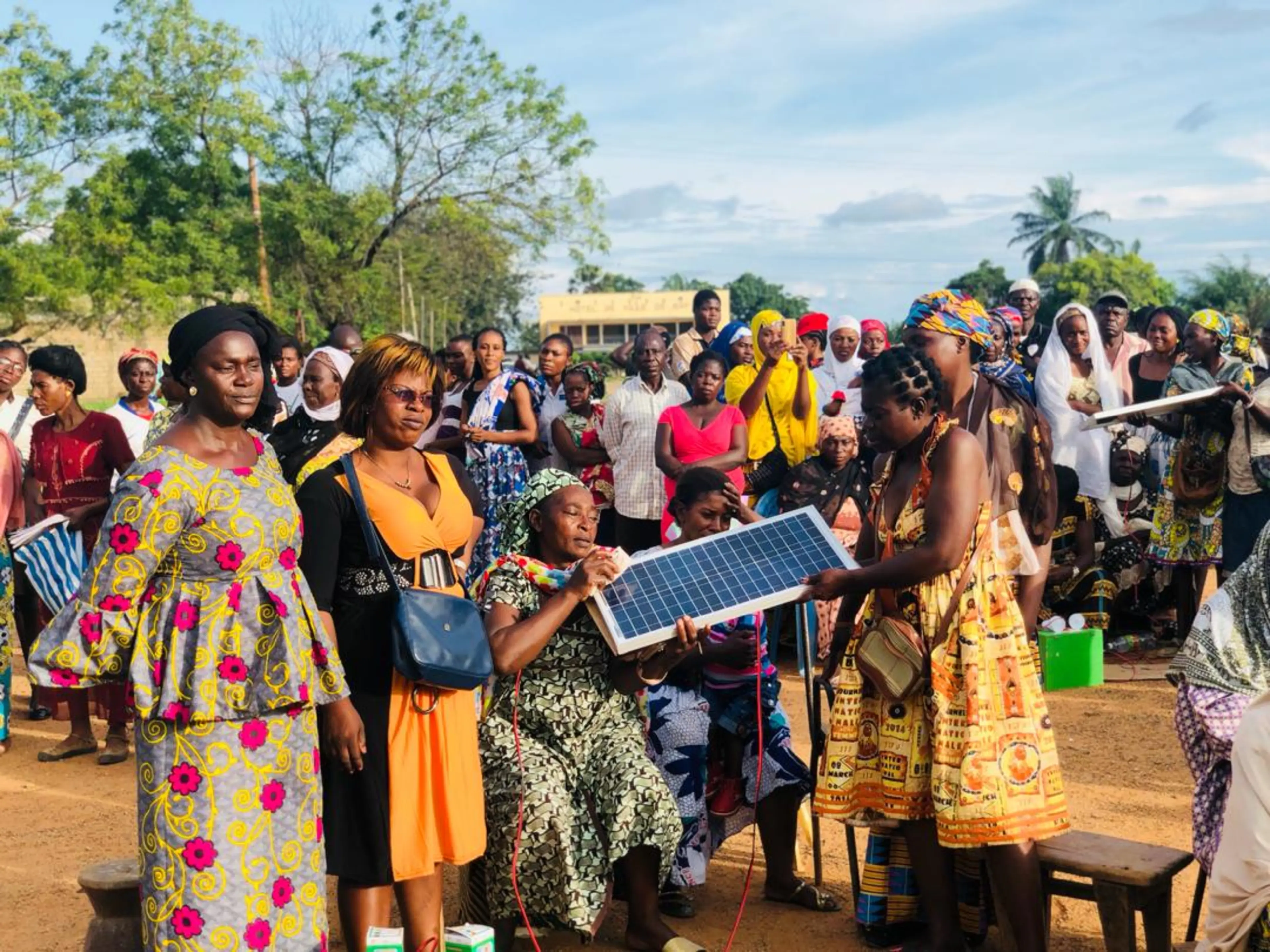 Village women in their groups replicating how they have been taught to clean their solar panels.