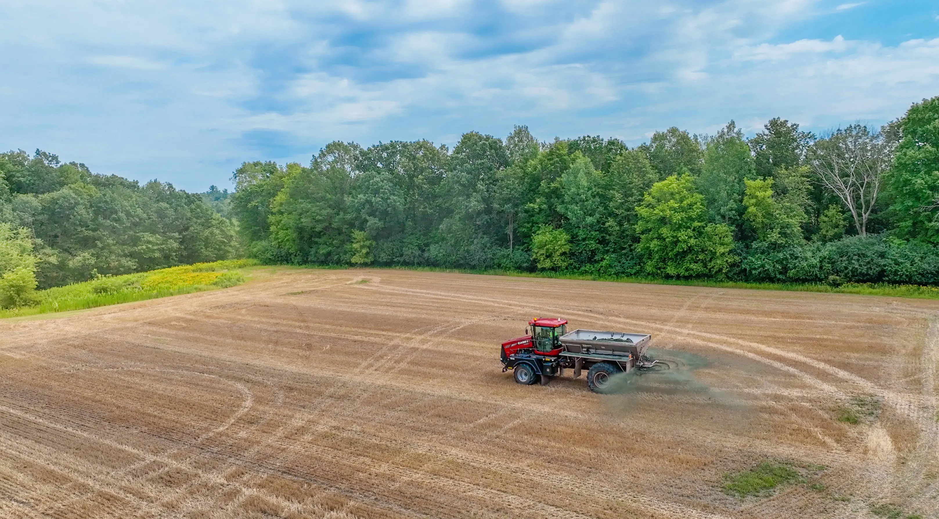 Tractor spreading basalt on farm for Lithos Carbon