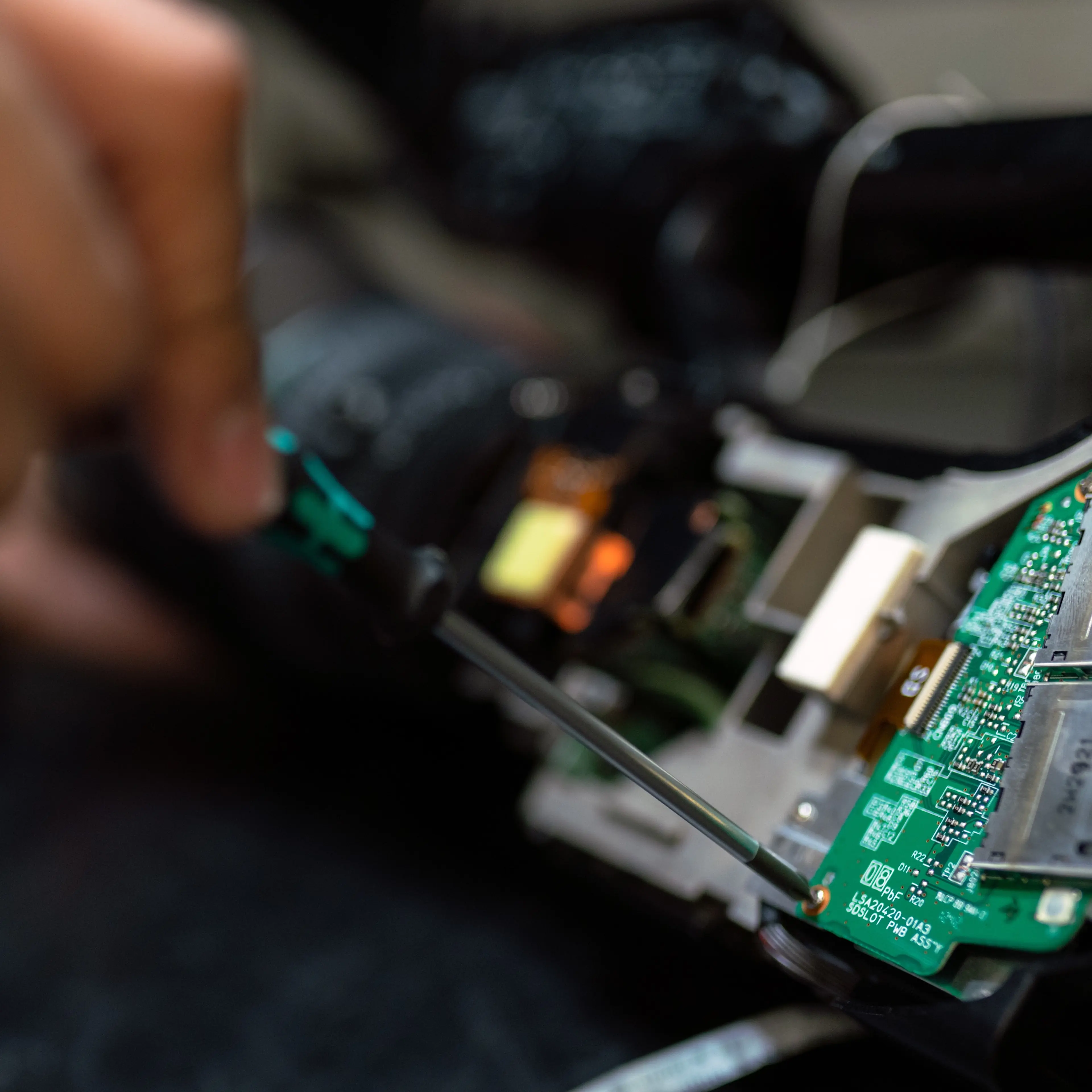 Image of person repairing electronic item.