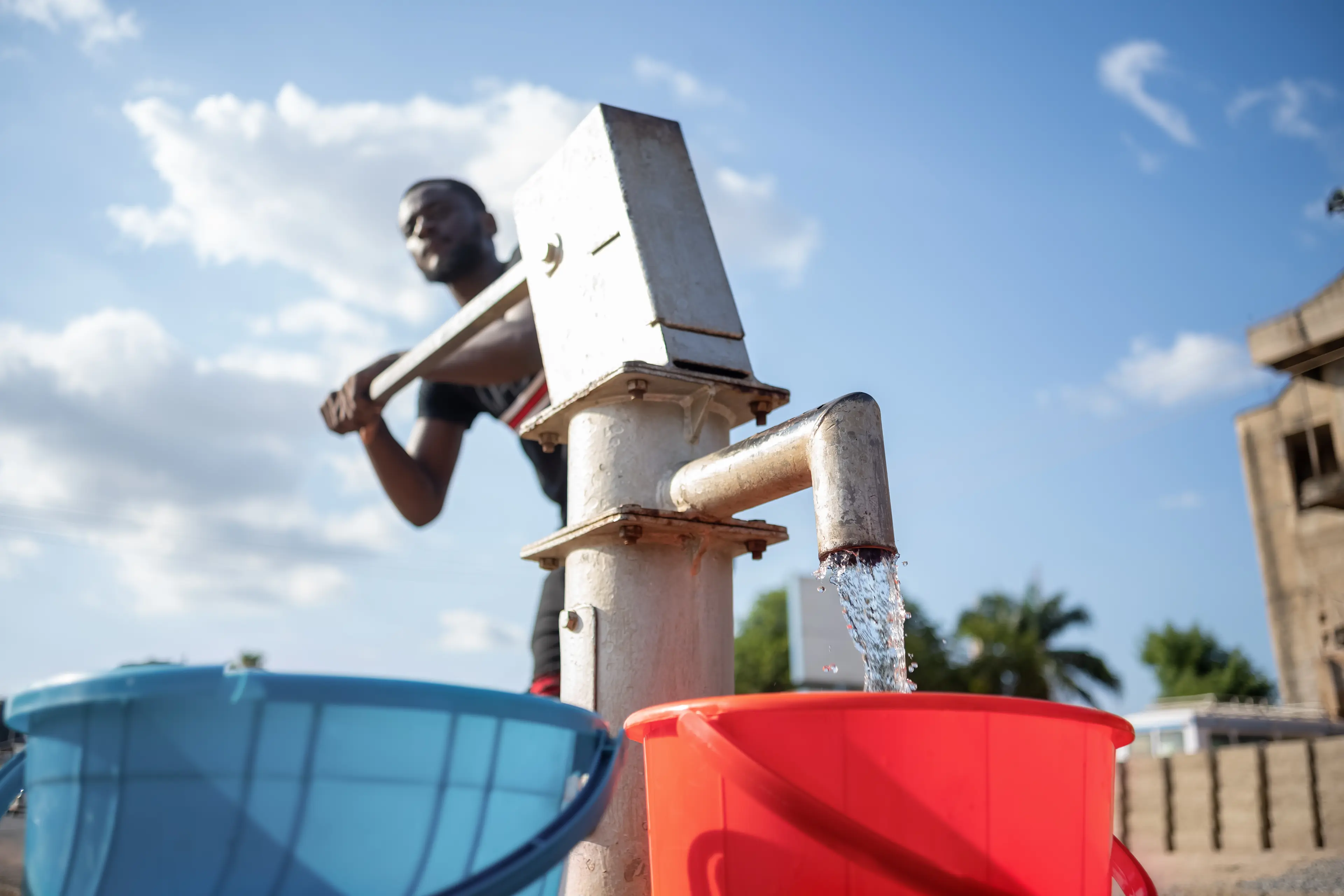 Water being pumped by hand from borehole