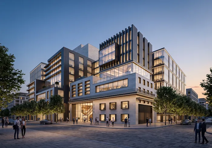 Stone-and-glass mixed-use building anchoring a lively downtown corner at golden hour.