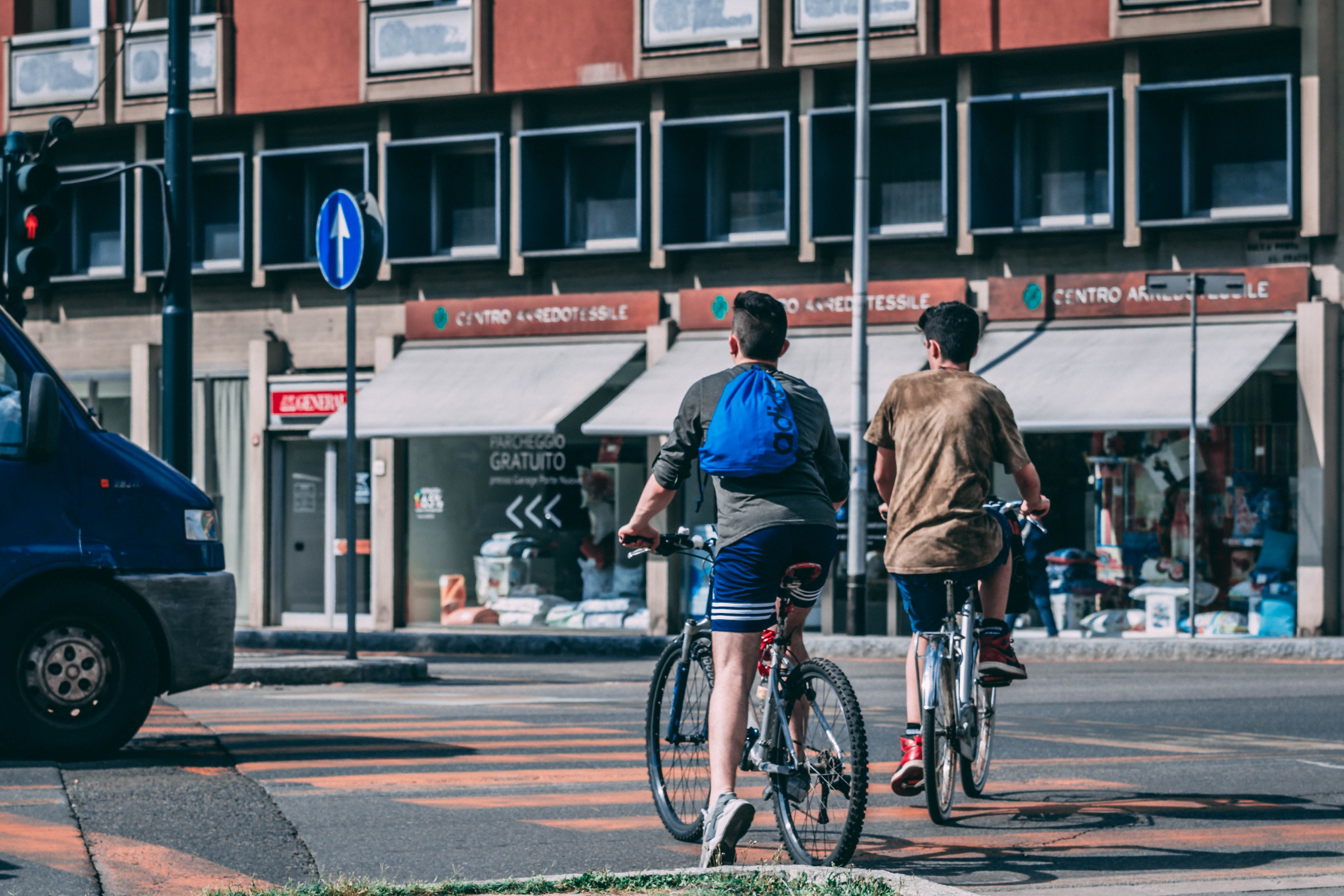 men-riding-bicycles-traveling-on-road-near-red-and-gray-1144268