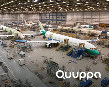A Quuppa logo over an image of a airplane manufacturing facility
