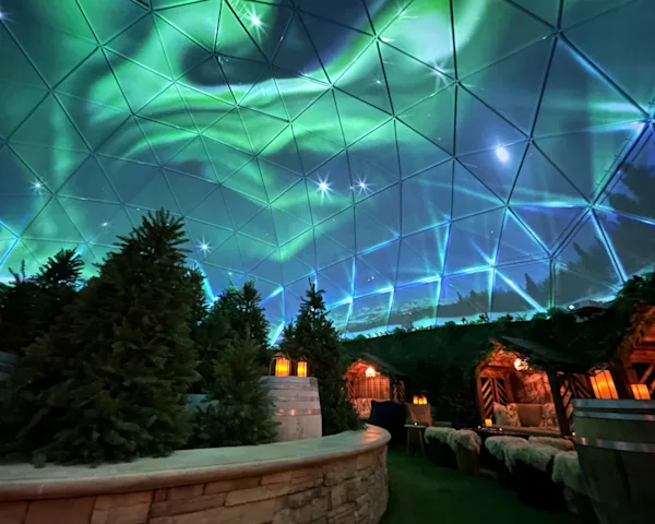 An indoor space with the aurora borealis projected on the ceiling