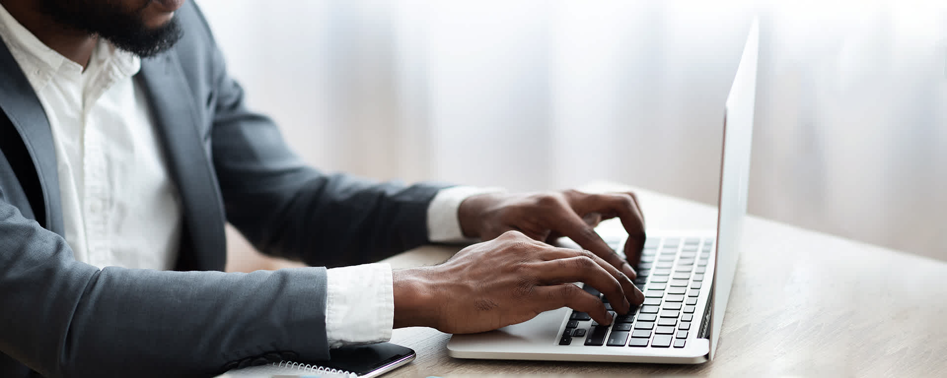Employee working on laptop in modern office | Blog