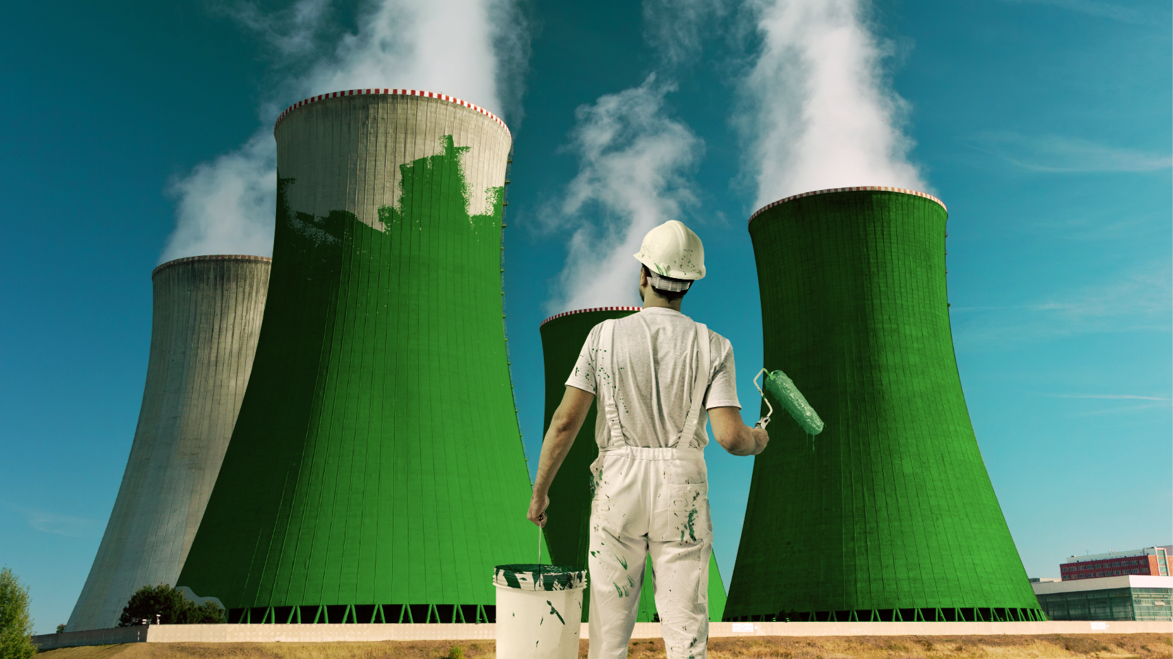 A painter has rolled green paint onto four cooling chimneys