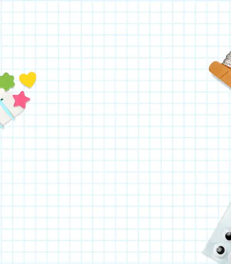 A sheet of graph paper with crafts strewn about