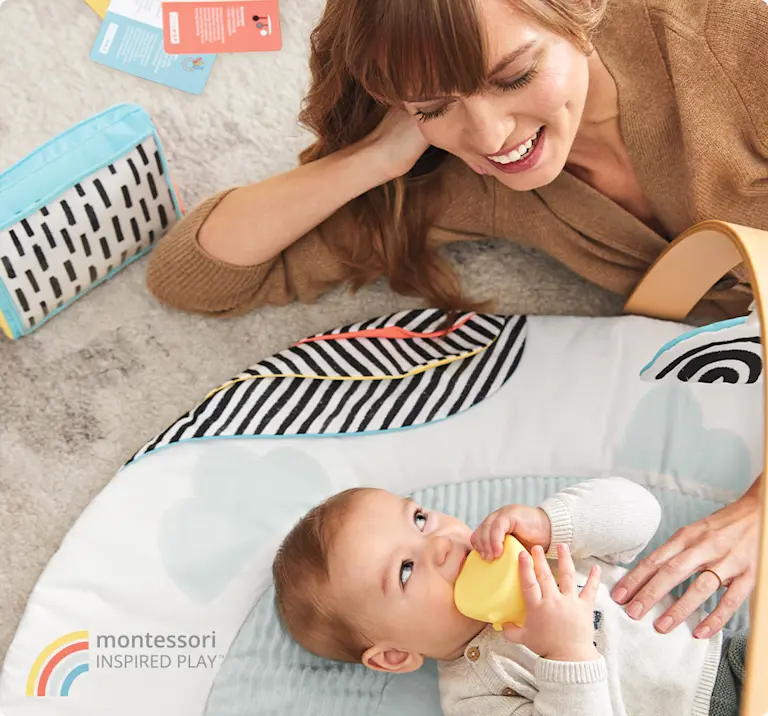 Parent and baby on play mat