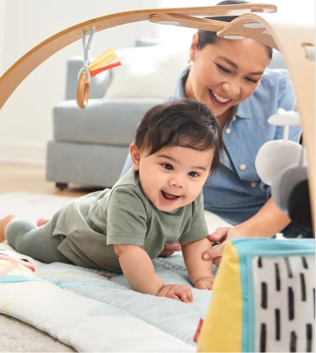 Parent and Baby interacting with activity gym