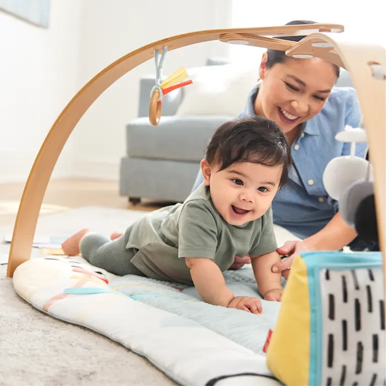 Baby playing on activity gym