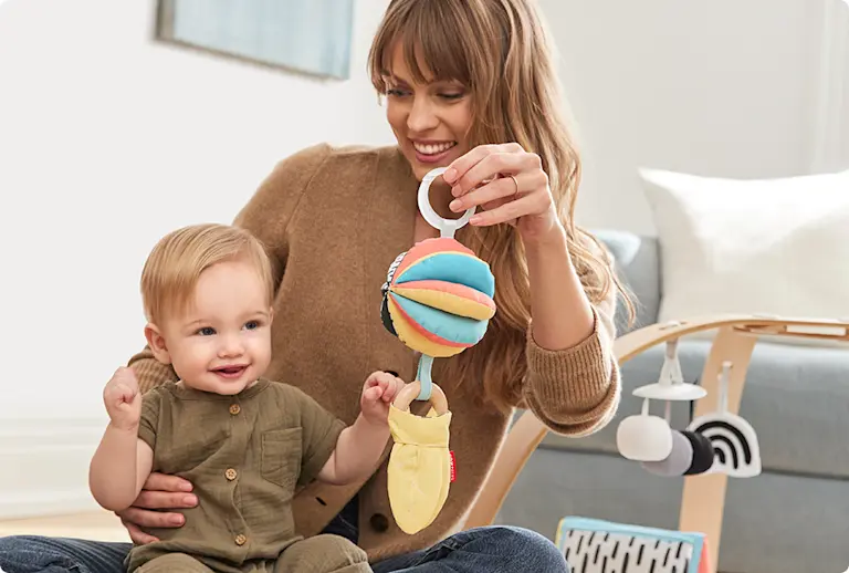 Parent showing child a toy
