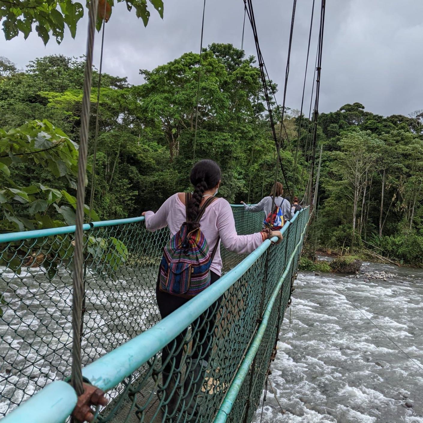 Girls crossing a bridge in costa rica