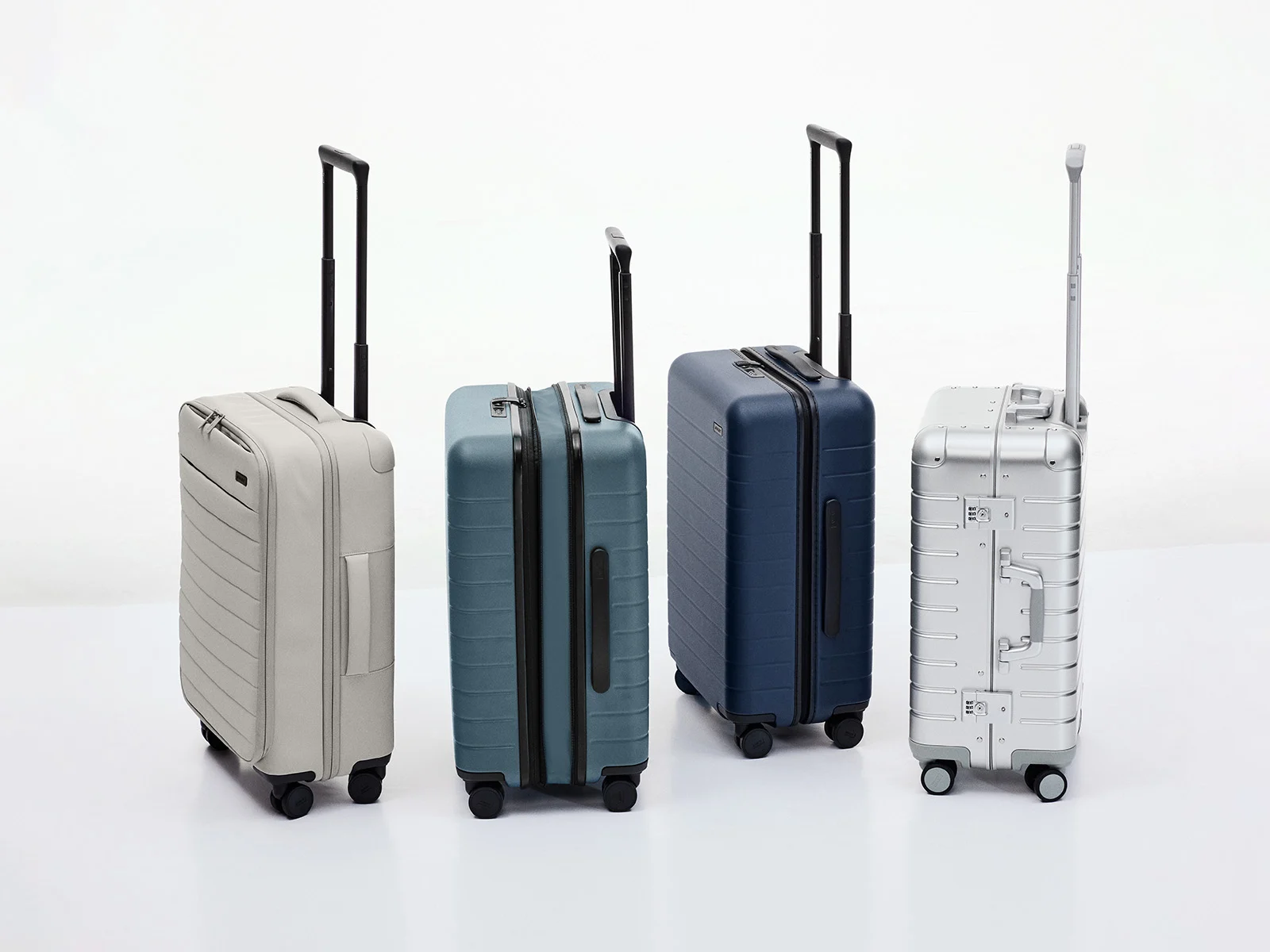 A variety of Away suitcases in classic hardshell polycarbonate, aluminum, and nylon softside